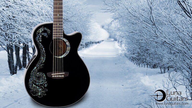 Black acoustic guitar with dragon in snow
