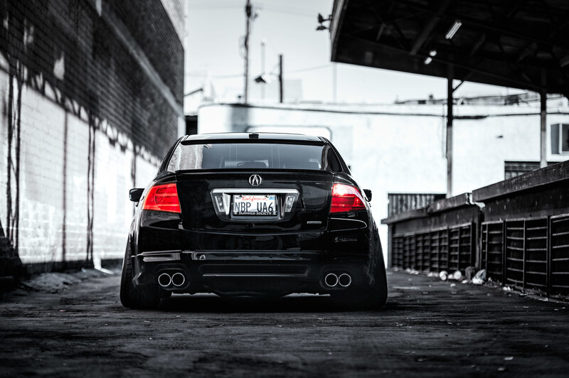 Black Acura in an alley