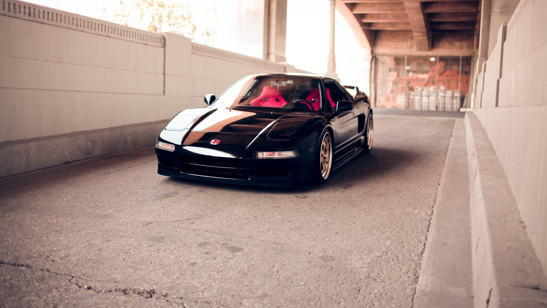 Black Acura NSX under a bridge