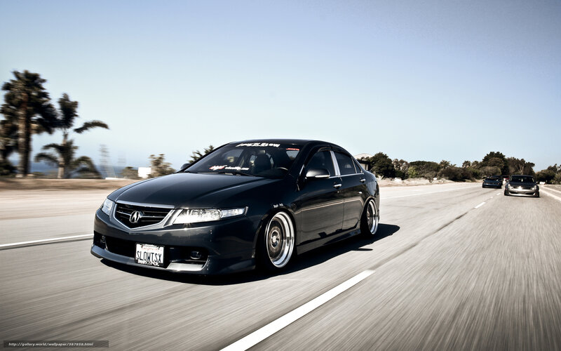 Black Acura on a coastal road
