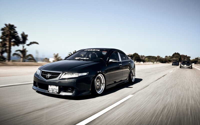 black acura on coastal road