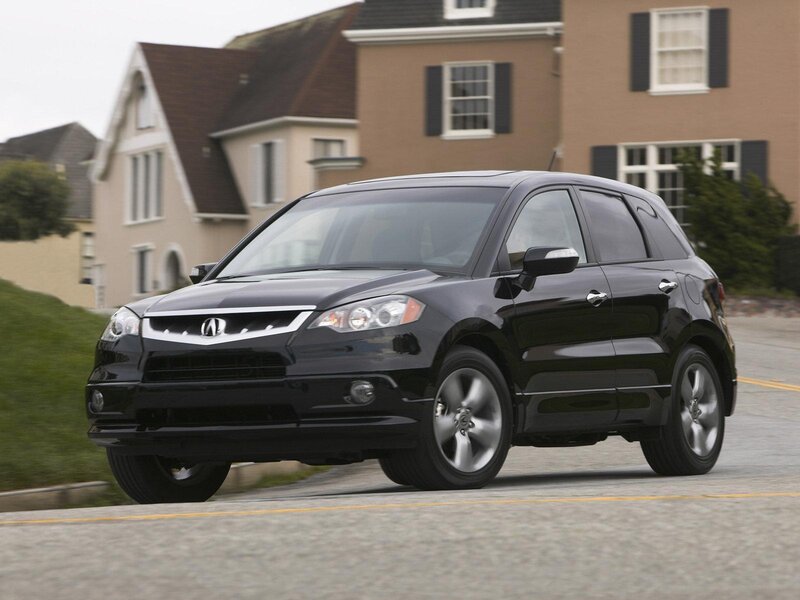 Black Acura RDX driving on street