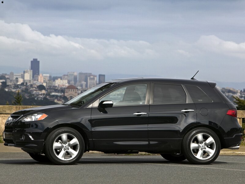 Black Acura RDX parked with city view