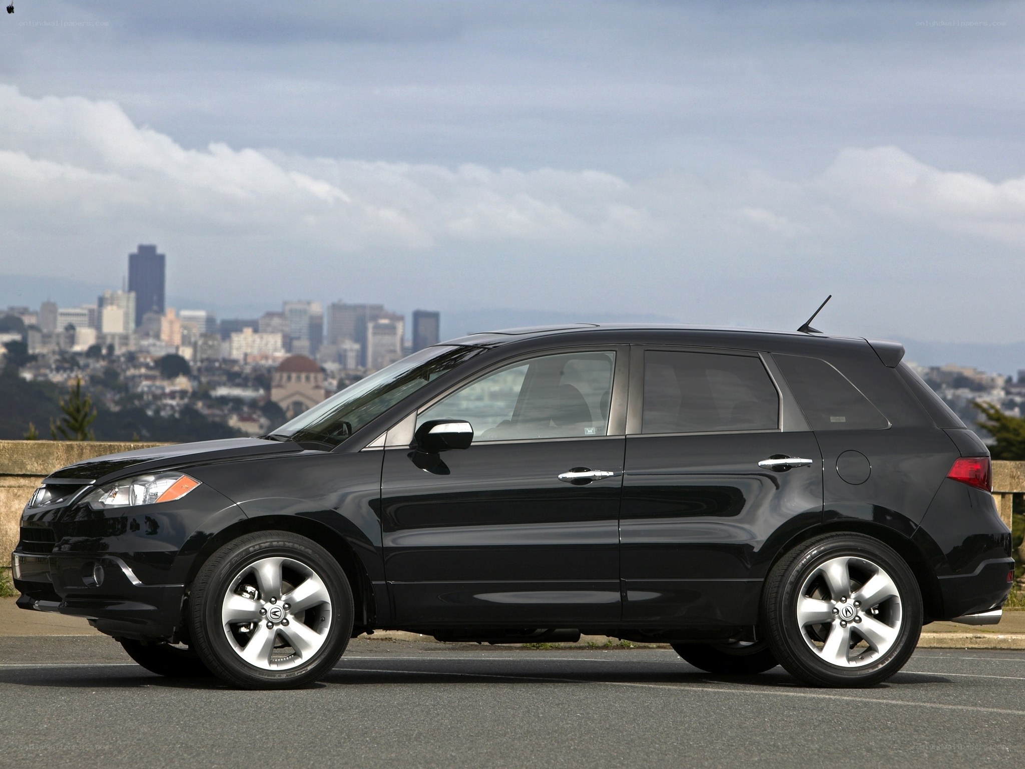 Black Acura RDX parked with city view