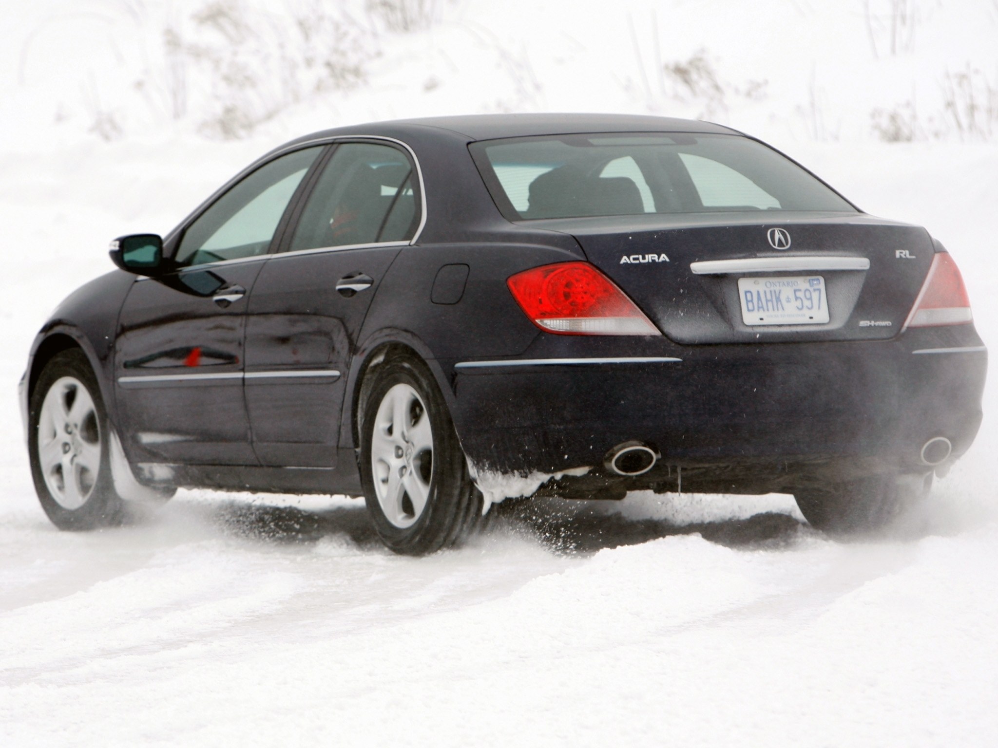 Black Acura RL in snow