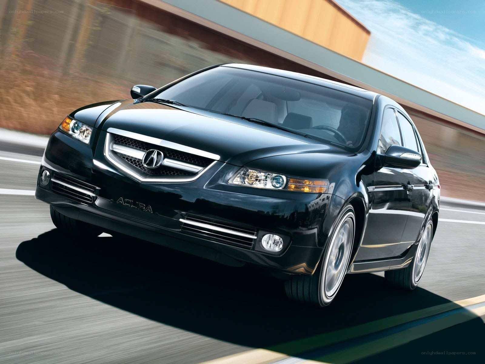 Black Acura TL in motion