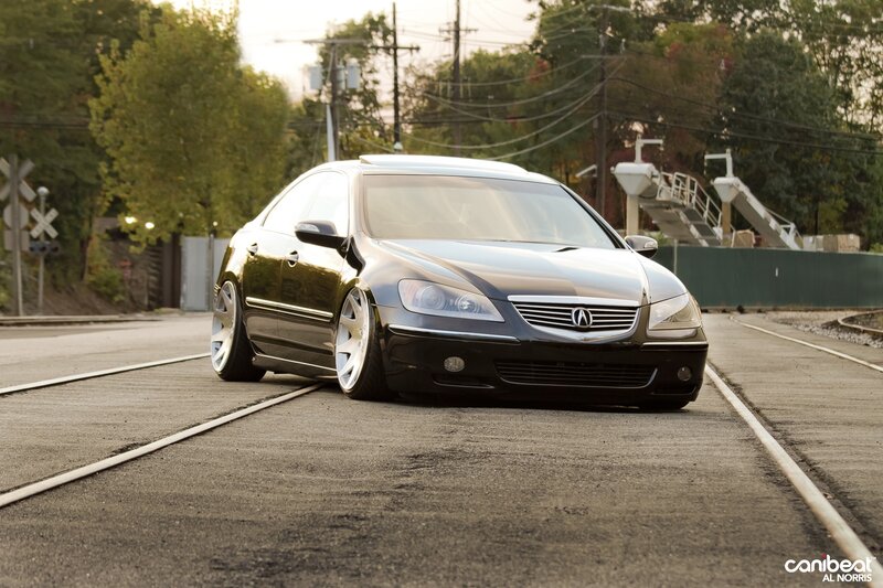 black acura tl on train tracks