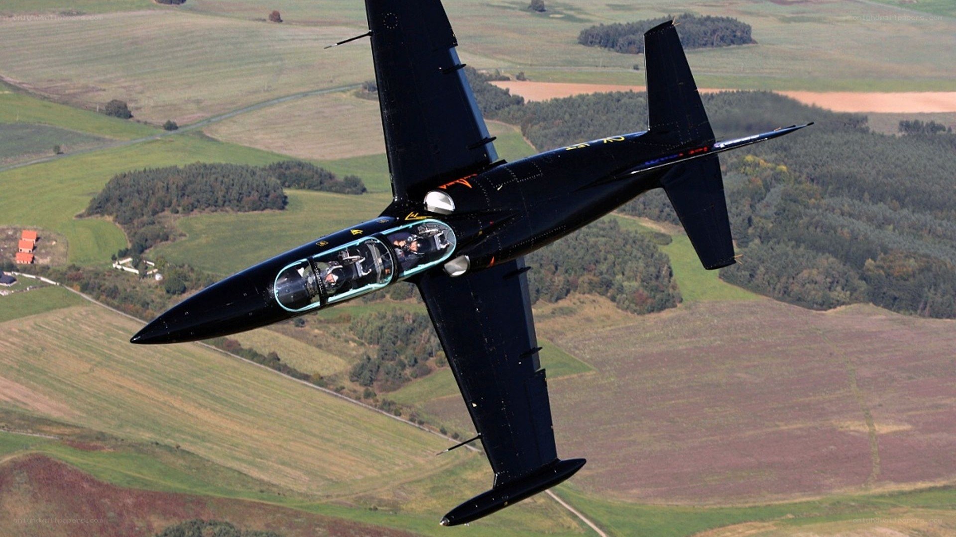 Black aerobatic jet in flight