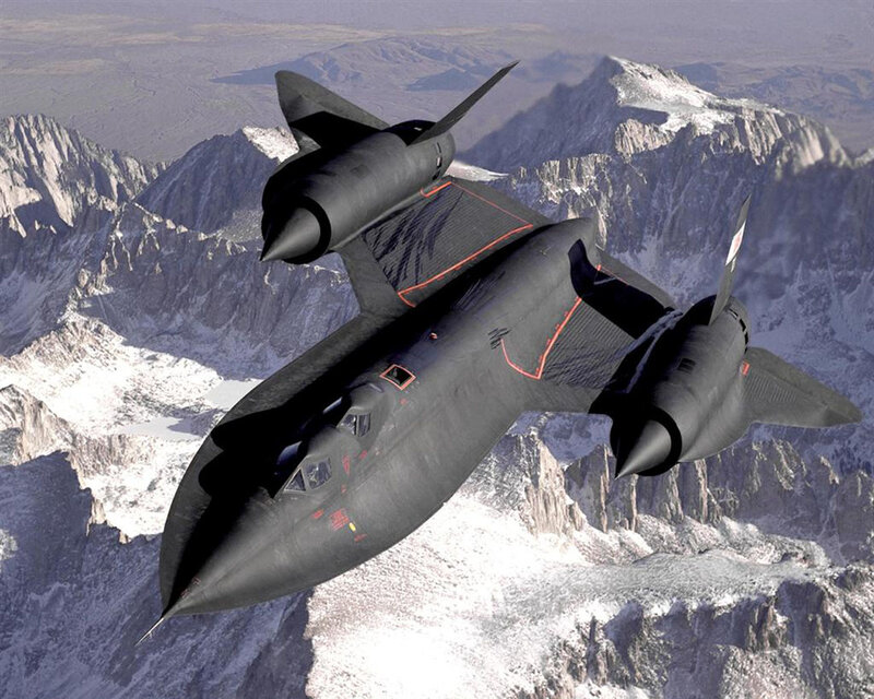 Black aircraft over mountains
