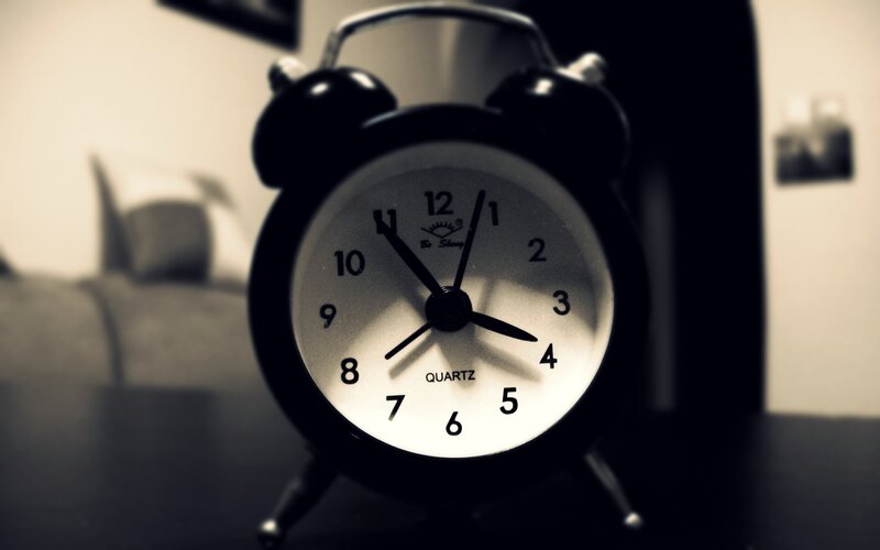 black alarm clock on table