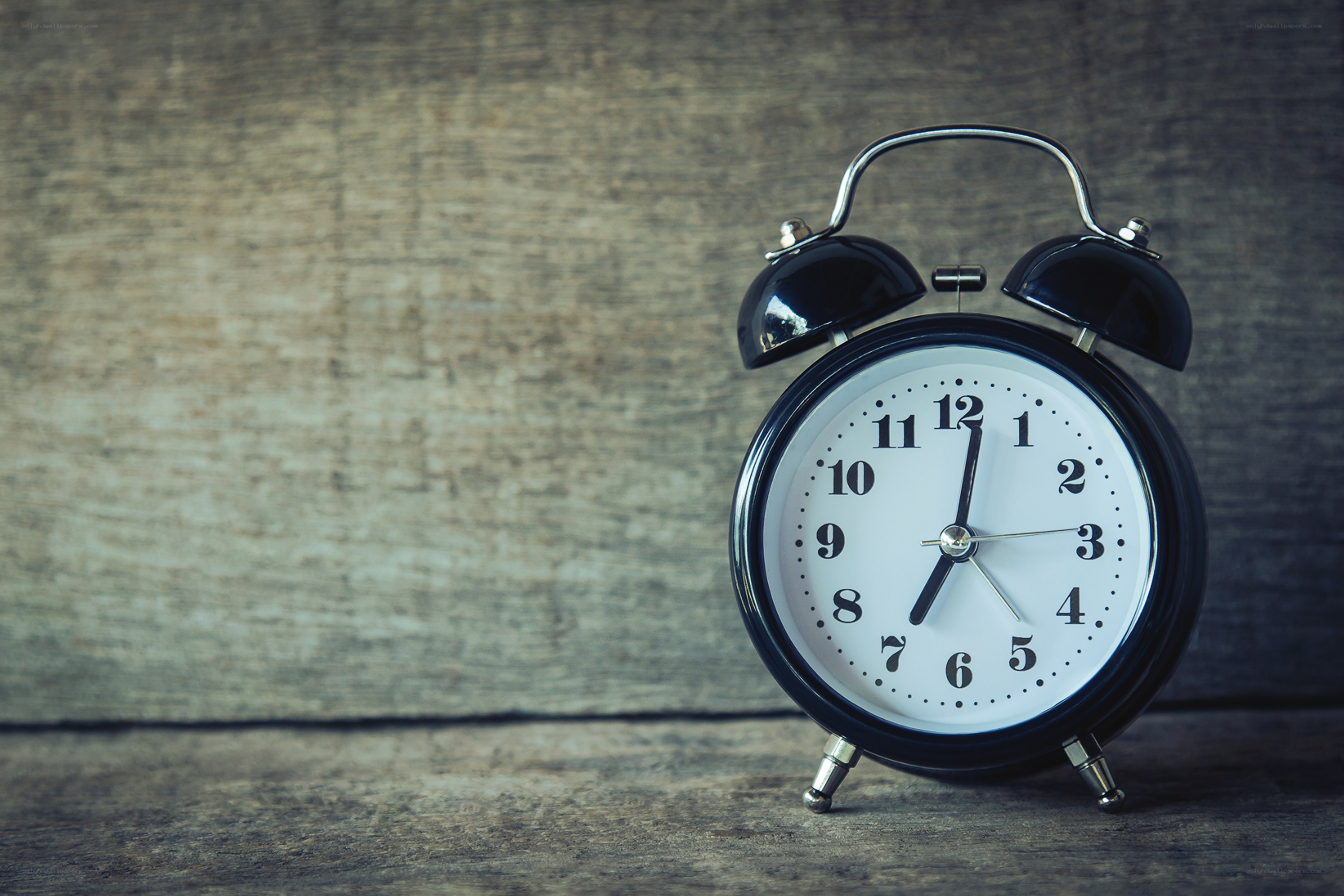 black alarm clock on wood