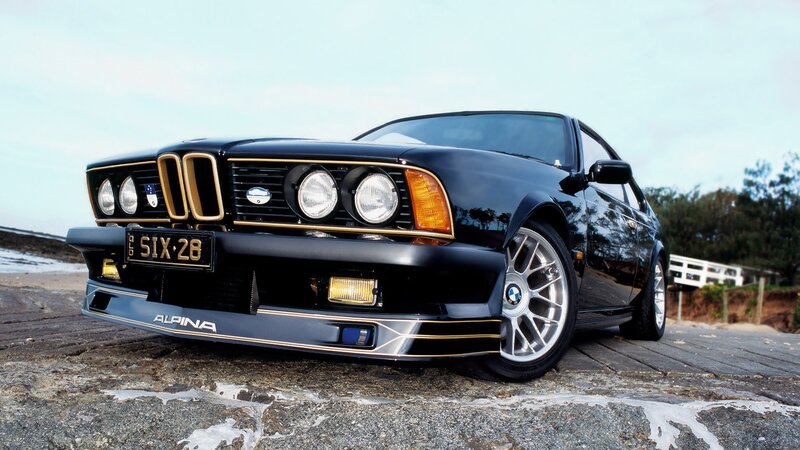 Black Alpina BMW on coastal road