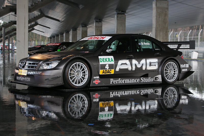 Black AMG race car on wet track