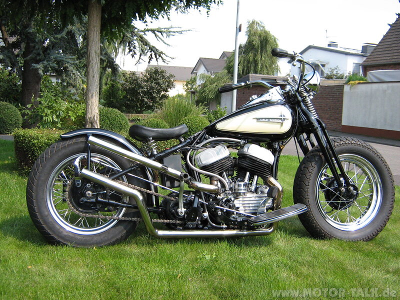 black and cream motorcycle on grass