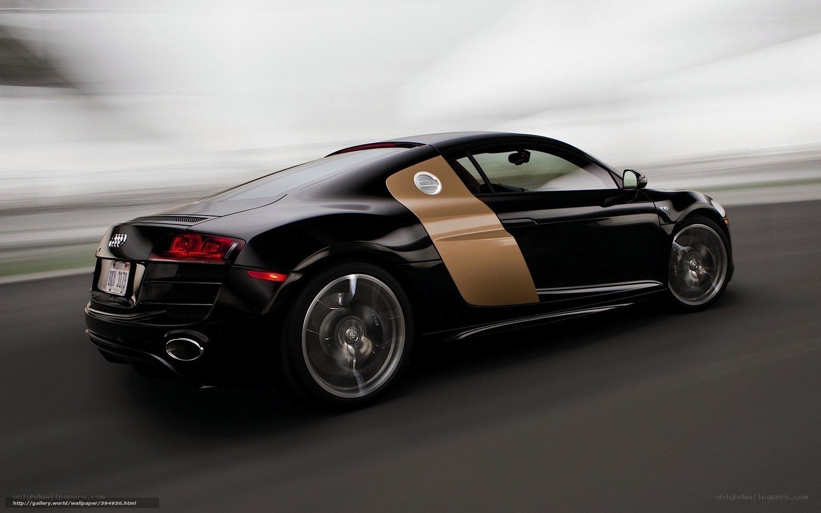 Black and gold Audi R8 in motion