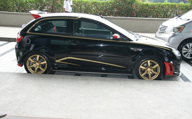 black and gold car with custom wheels