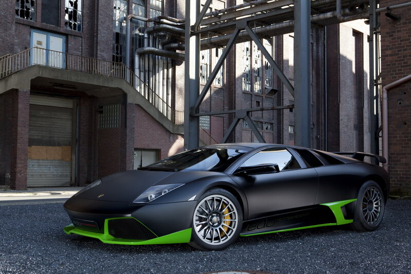 Black and green Lamborghini in industrial setting