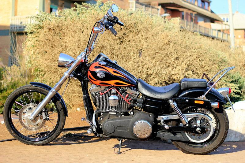Black and Orange Motorcycle — Calm, Afternoon, Photograph, Bushes