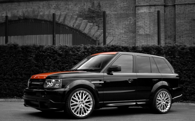 Black and Orange SUV — Dramatic, Photograph, Car, Hedge, Brick Wall