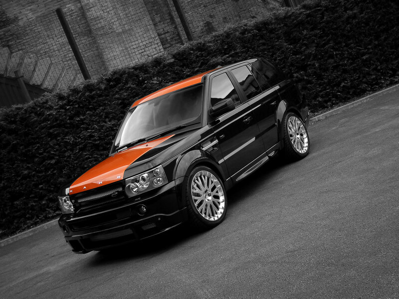 Black and Orange SUV — Dramatic, Photograph, Hedge, Road, Building