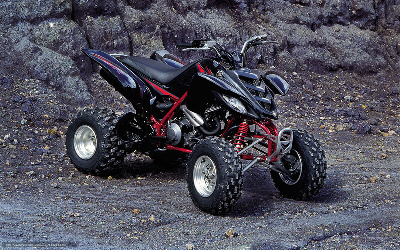 Black and red ATV on rocky terrain
