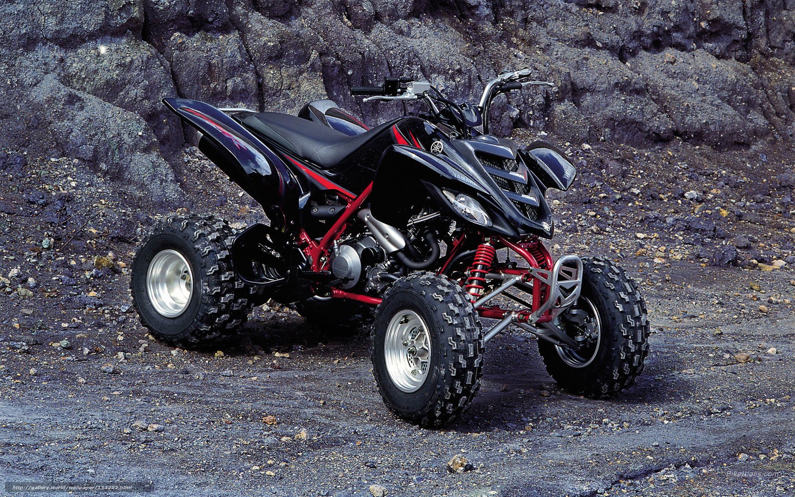 Black and red ATV on rocky terrain