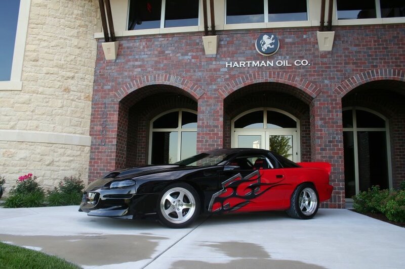 black and red car in front of building