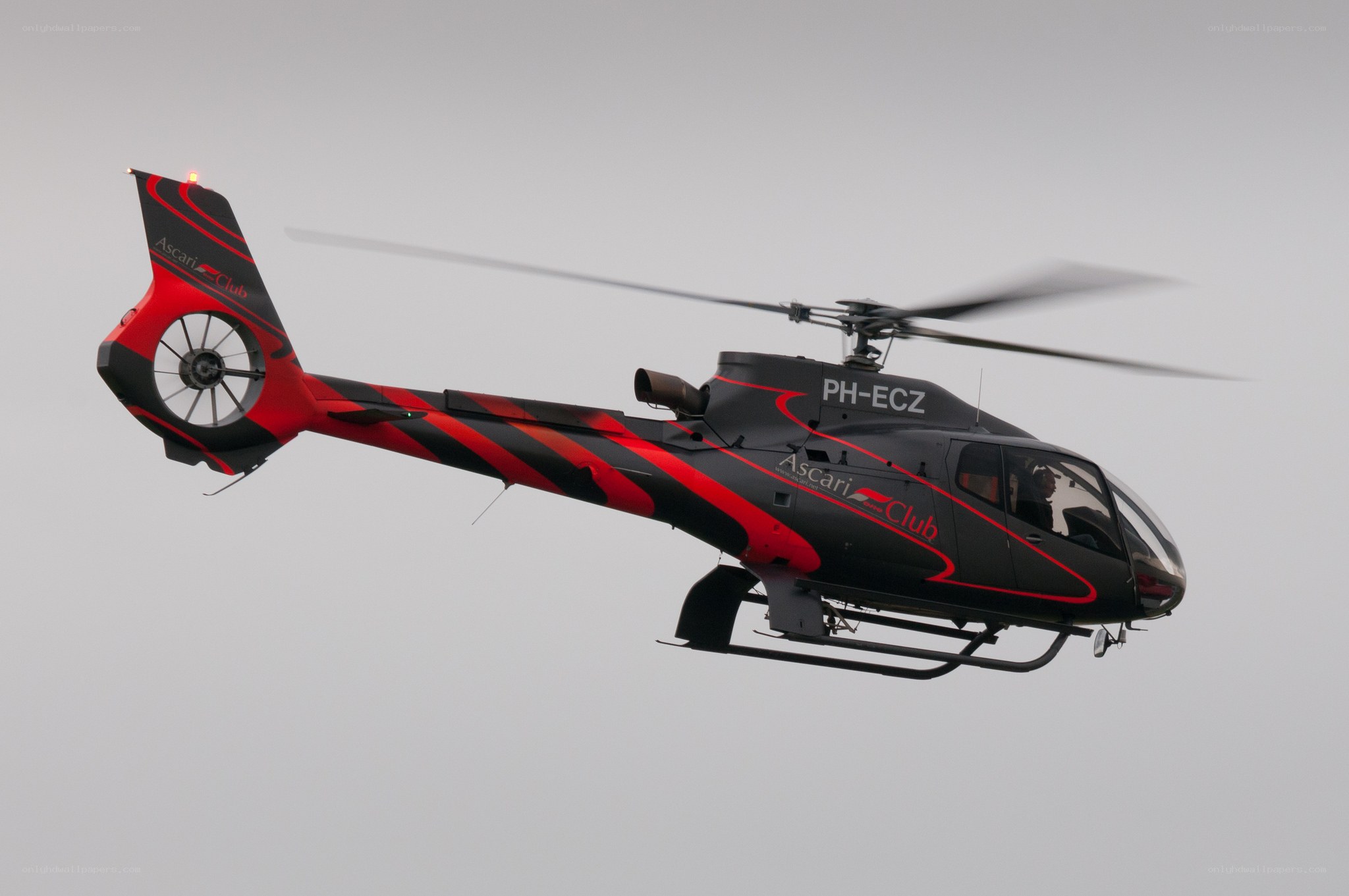 Black and red helicopter in flight