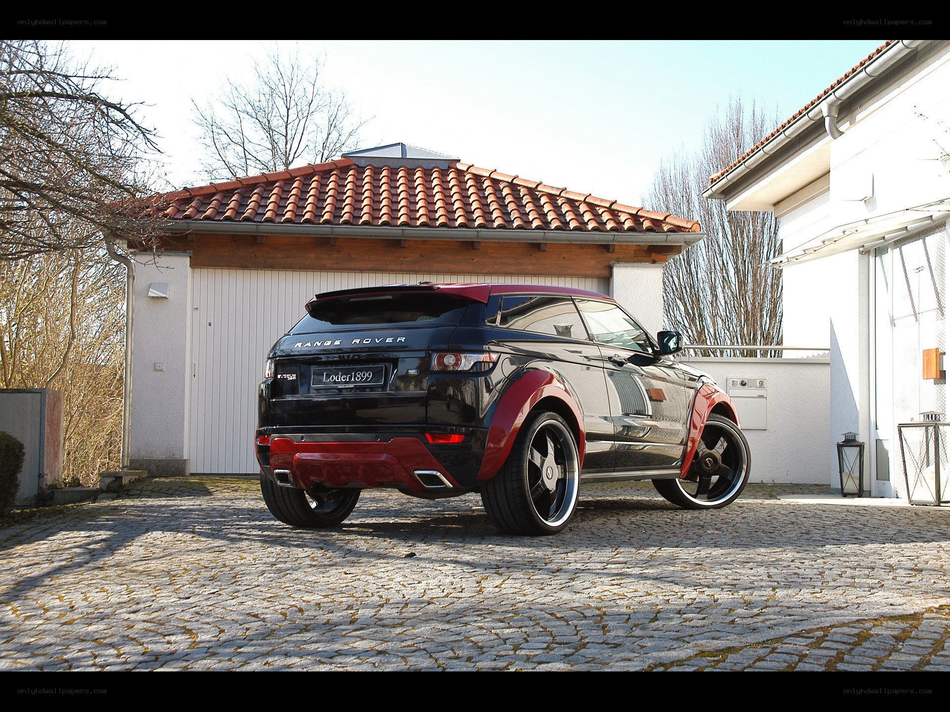 Black and red Range Rover parked outside
