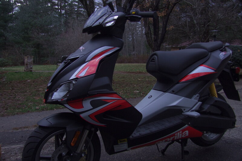 Black and red scooter in driveway