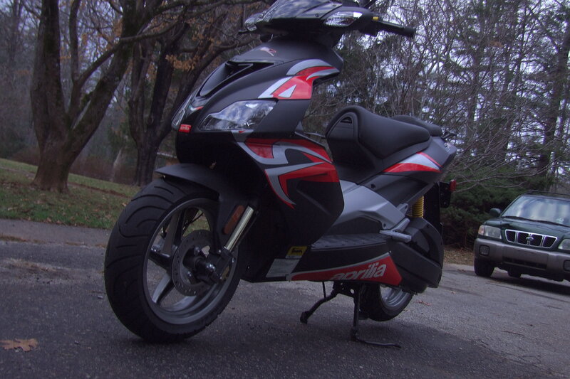 Black and red scooter on street
