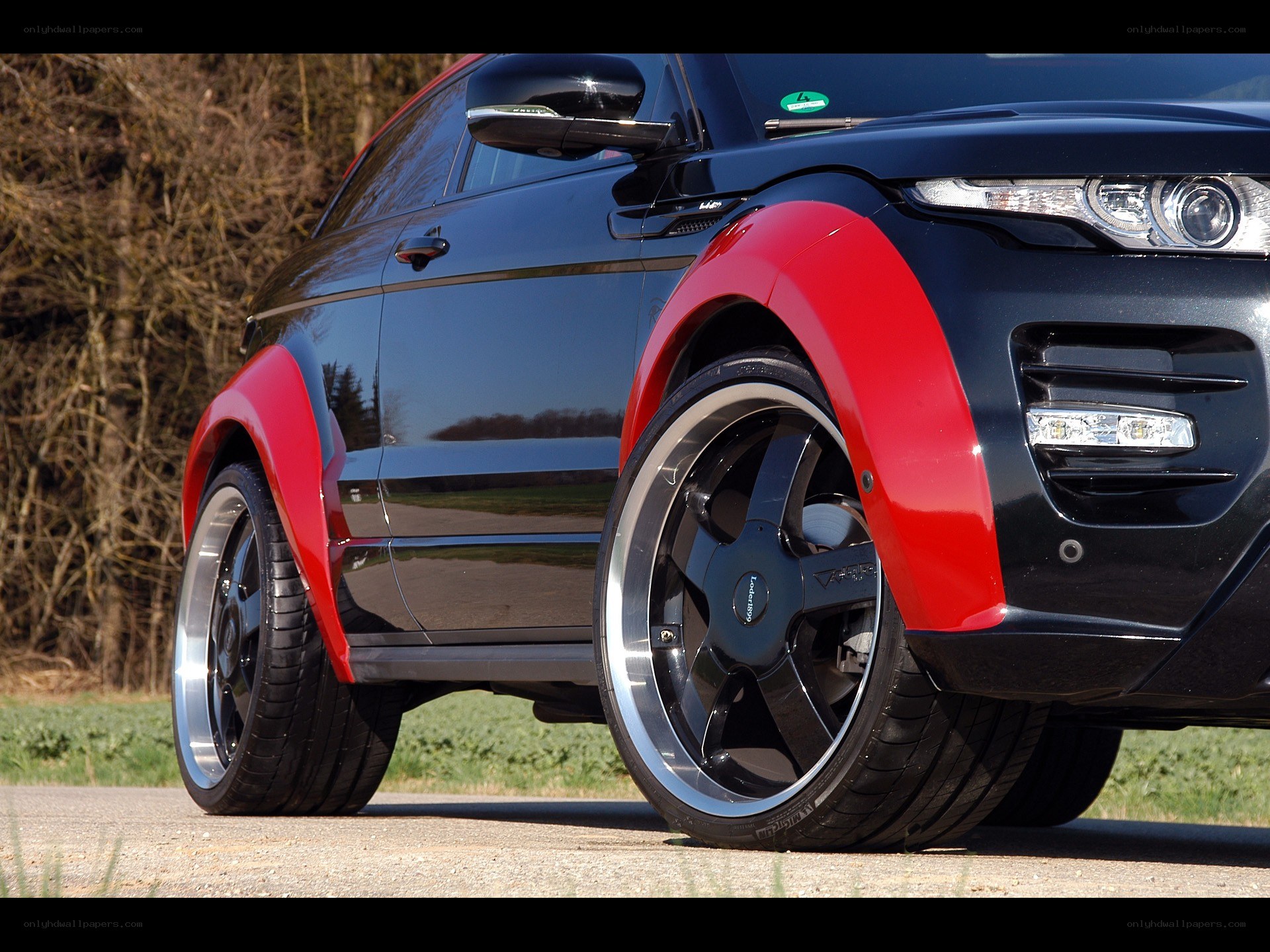 black and red SUV with custom wheels