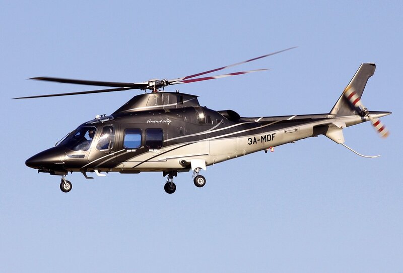 Black and silver helicopter in flight
