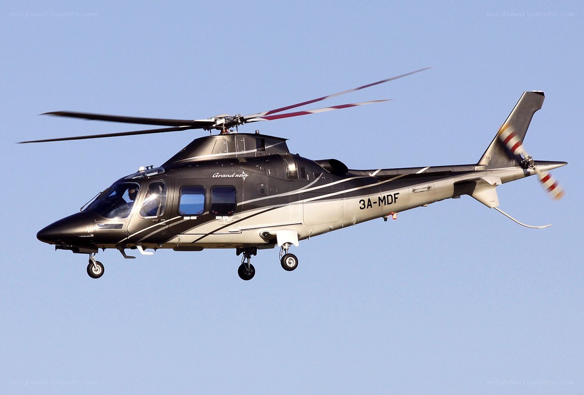 Black and silver helicopter in flight