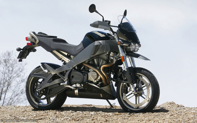 Black and silver motorcycle on gravel