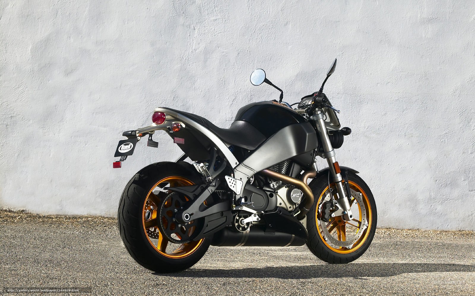 Black and silver motorcycle with gold wheels