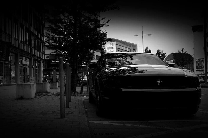 Black and white car on city street
