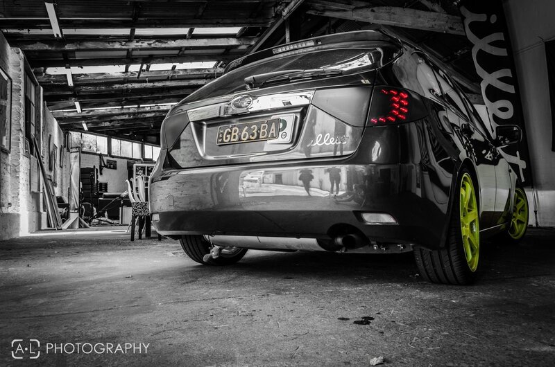Black and white car with neon wheels