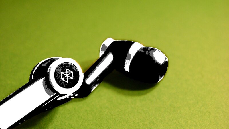 black and white earbuds on green
