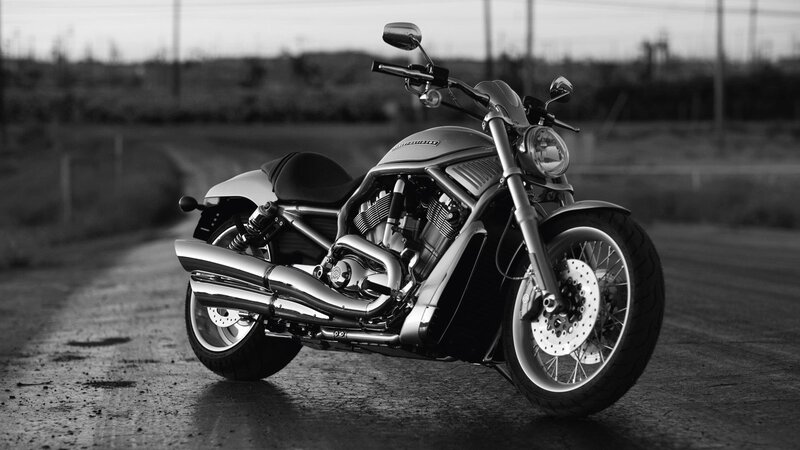 black and white motorcycle on road