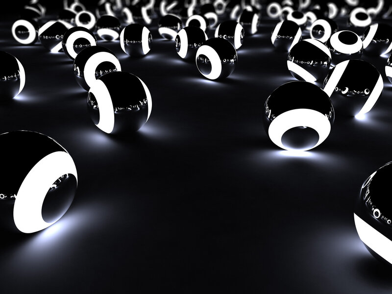 black and white spheres on dark surface