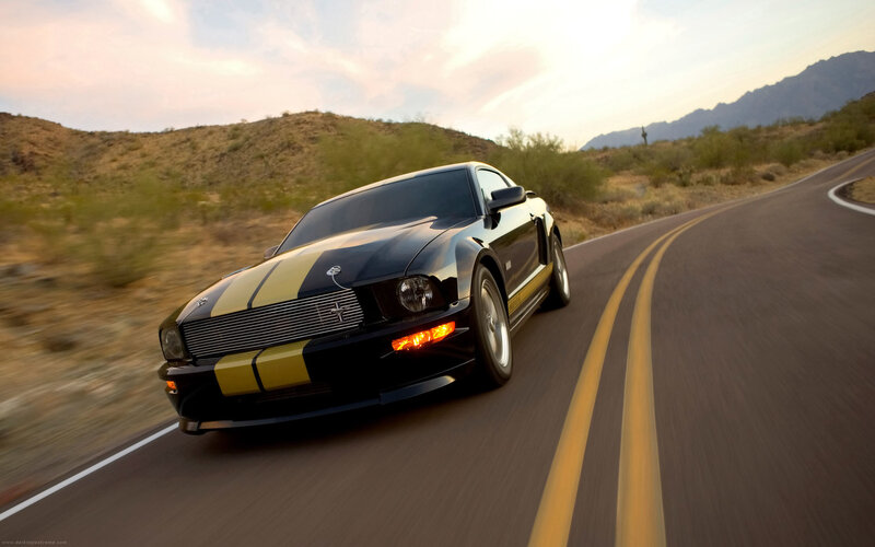 black and yellow mustang on desert road