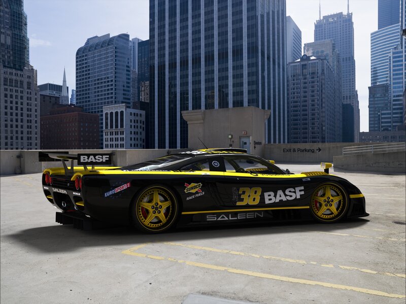 Black and yellow race car in city