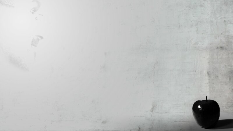 black apple on white wall