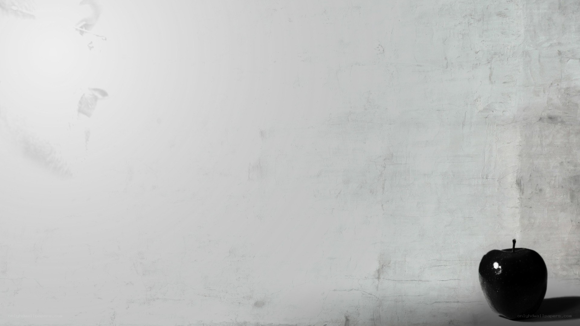 black apple on white wall