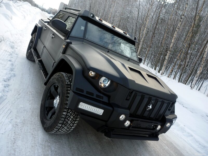 black armored vehicle on snowy road