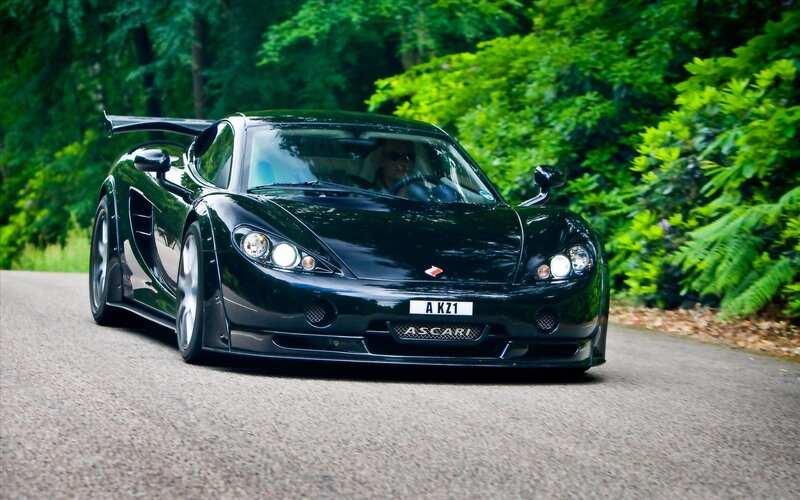 Black Ascari sports car on road