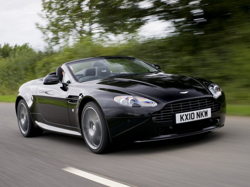Black Aston Martin convertible in motion