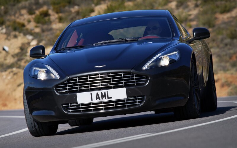 black aston martin driving