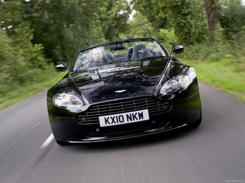 black aston martin driving on road
